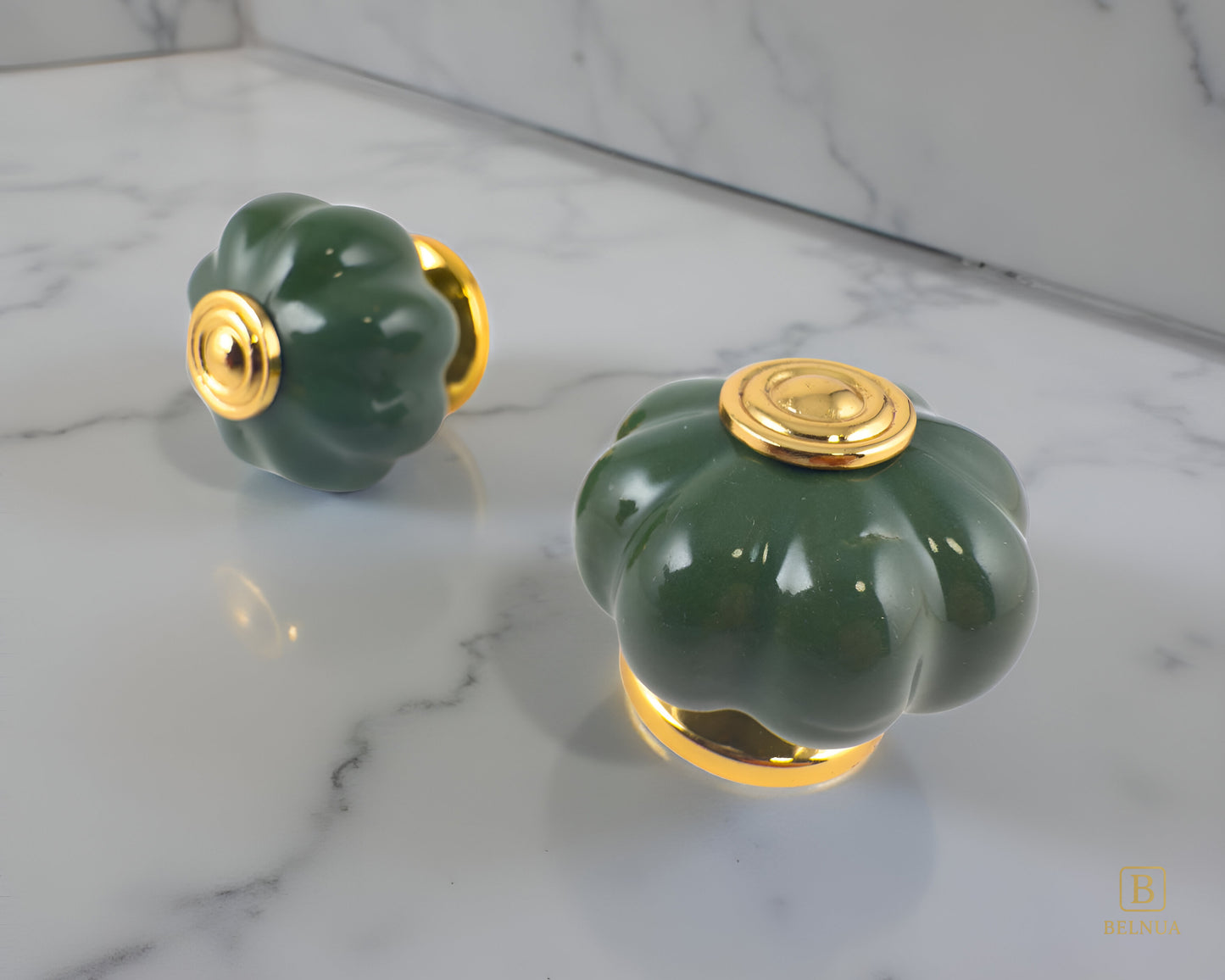 Belnua - Left side and top view of Tavira gold base knob with dark green porcelain insert  on grey marble surface