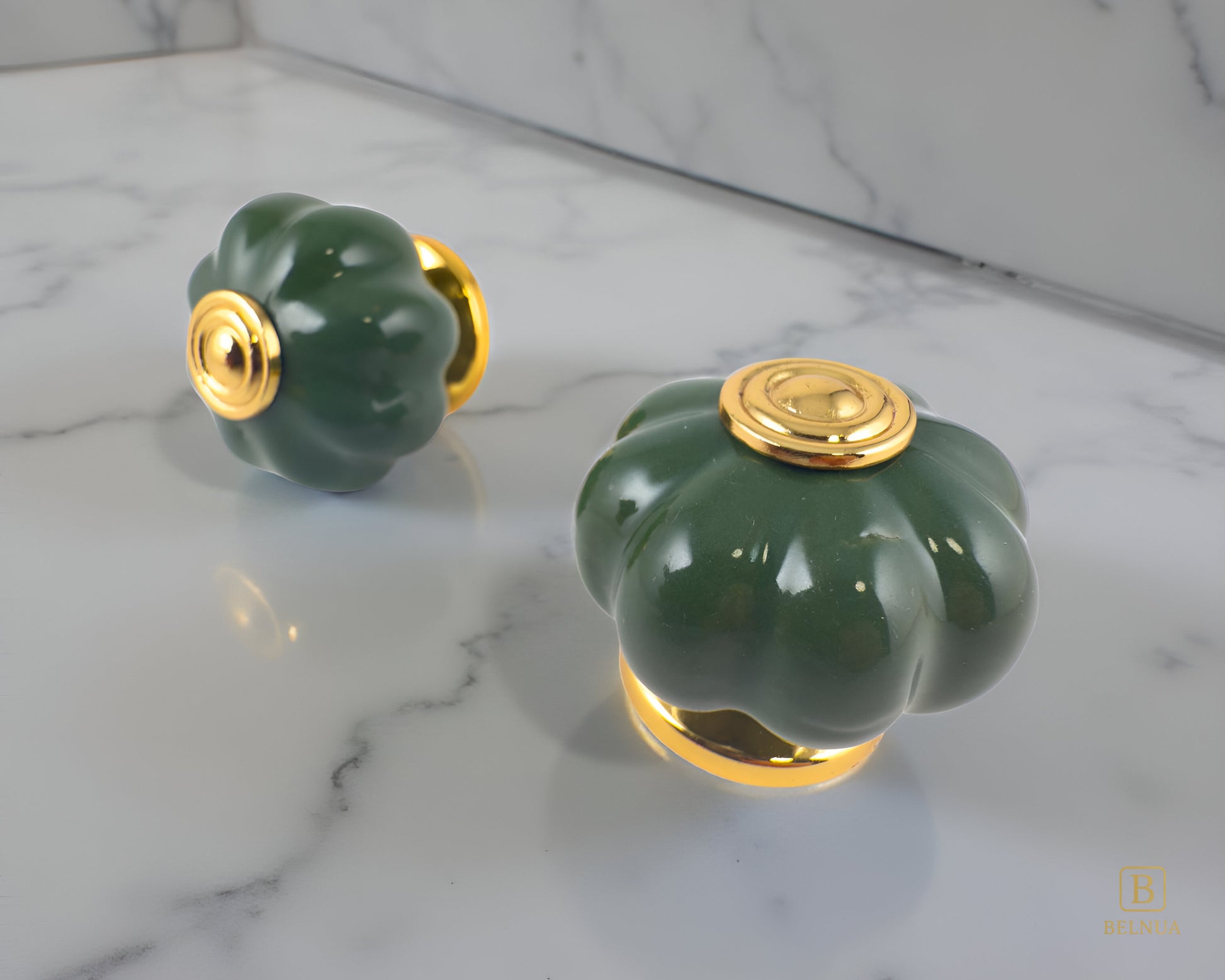 Belnua - Left side and top view of Tavira gold base knob with dark green porcelain insert  on grey marble surface