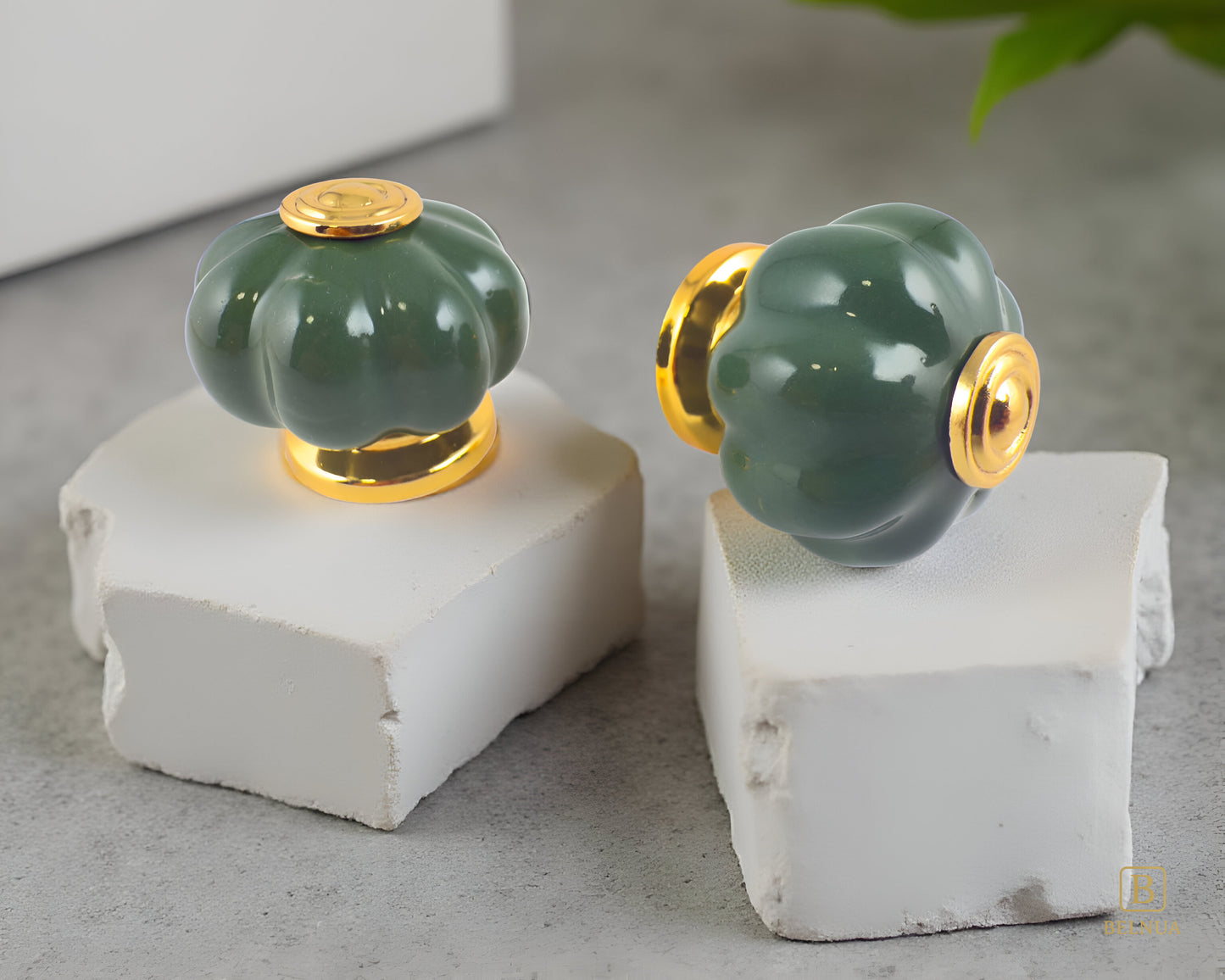 Belnua - Closeup view of Tavira porcelain/ceramic knob pair with left side and top view on cracked stone pieces 