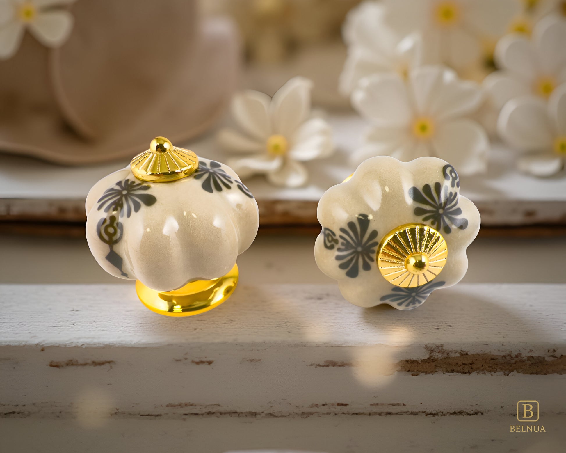Belnua -Top and front view of Tavira antique brown cabinet porcelain/ceramic knob with gold base featuring golden regal wreath motif on floral background and vintage wood background