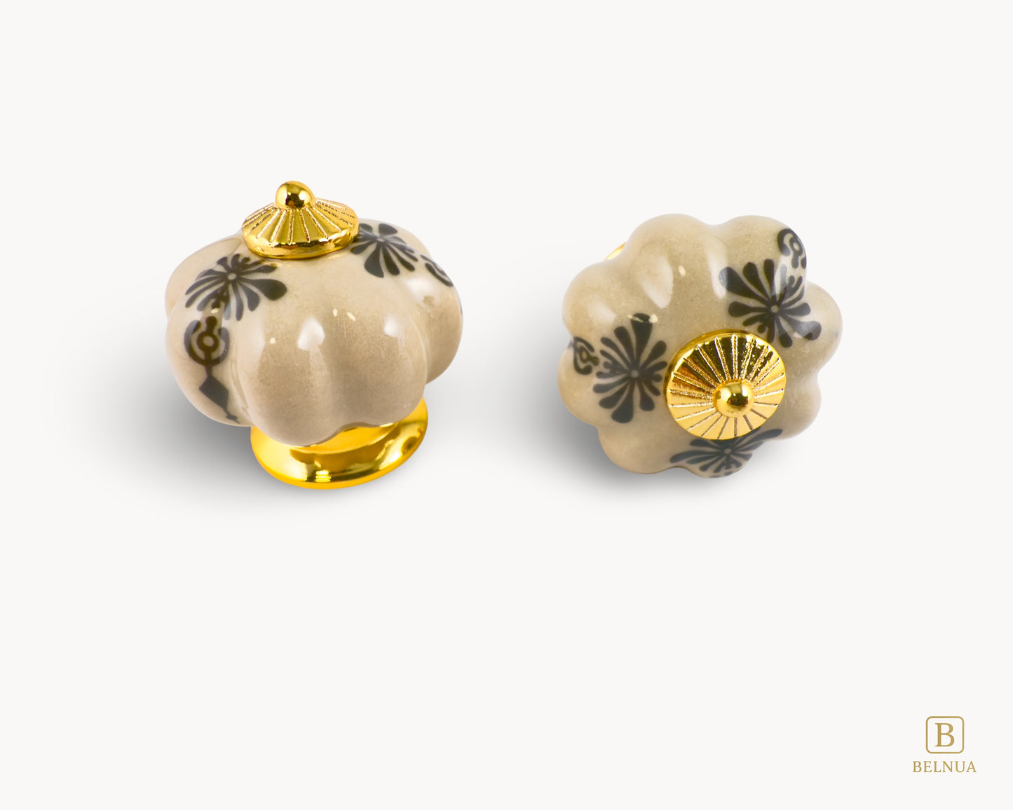 Belnua - Top and front of Tavira antique brown kitchen cabinet porcelain knob with gold base featuring golden regal wreath motif. 