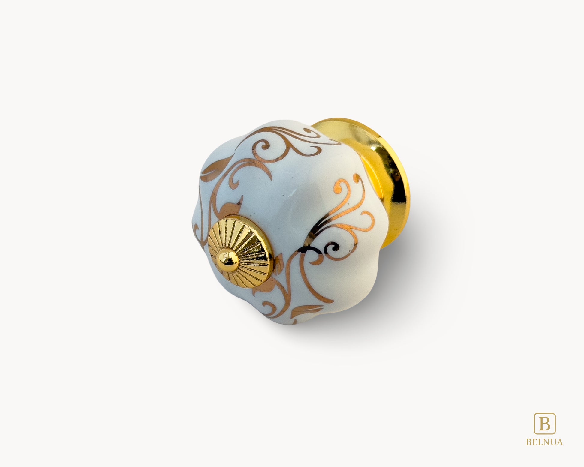 Belnua - Left view of Tavira white porcelain cabinet knob with delicate petal motif inserted on gold metal base.
