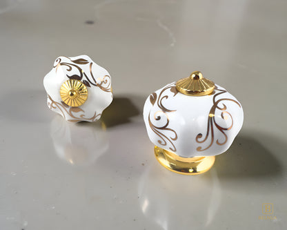 Belnua - Top and front view of luxury Tavira white porcelain cabinet knob with gold metal base on kitchen beige quartz worktop