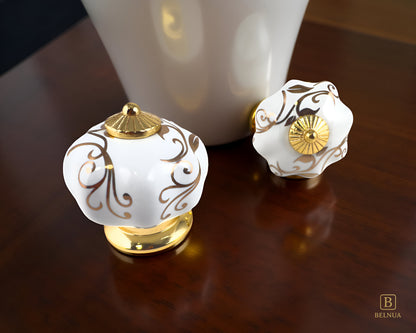 Belnua - Top and front view of luxury Tavira white porcelain cabinet knob pair with gold metal base on kitchen walnut worktop