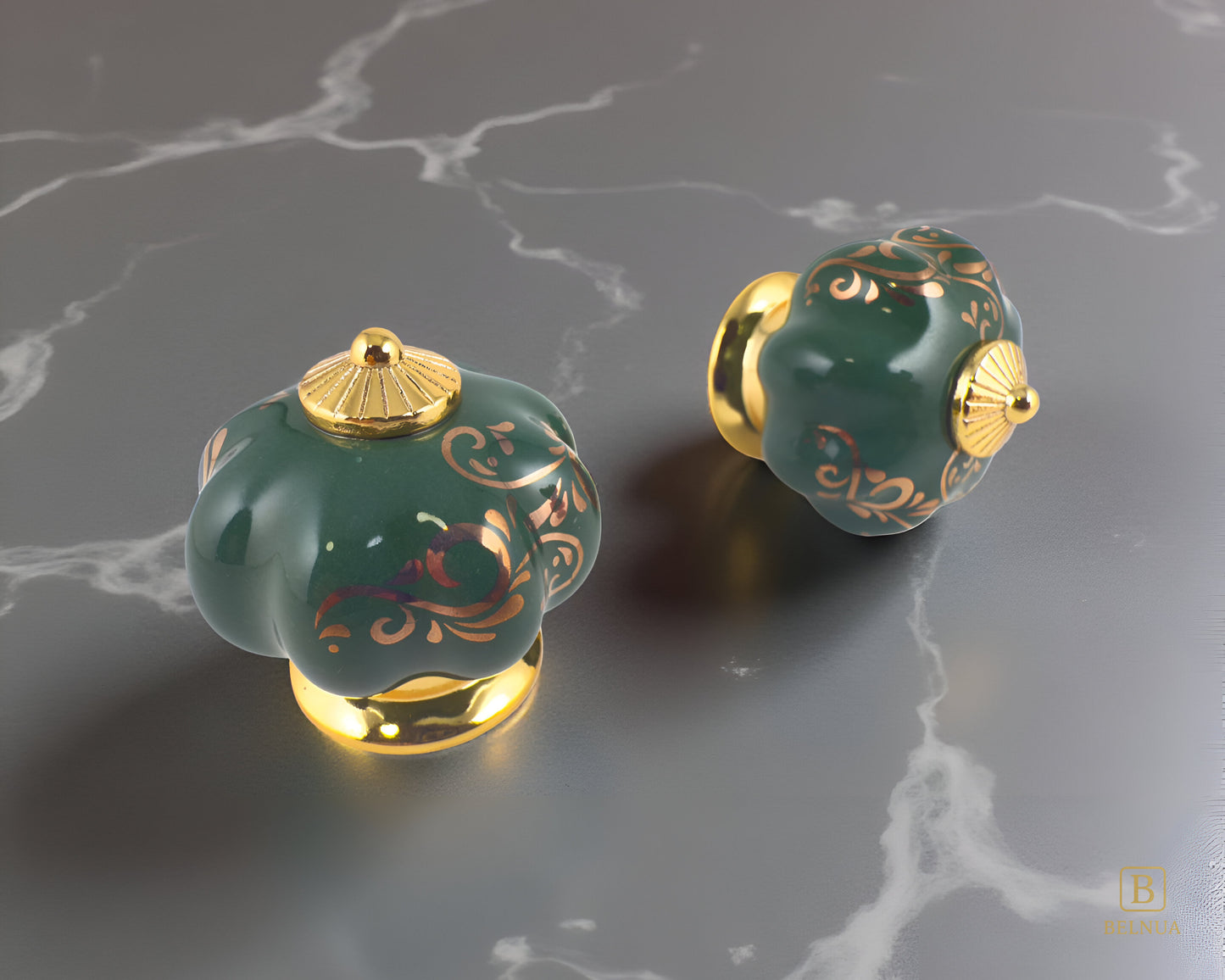 Belnua - Top and right view of luxury Tavira gold base with green porcelain cabinet knob pair with delicate golden vine cascade motif on grey marble kitchen surface