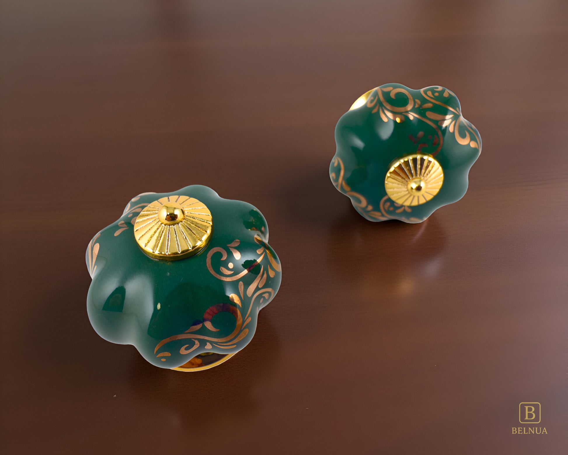 Belnua - Top and front view of luxury Tavira green porcelain cabinet knob pair with delicate golden vine cascade motif inserted gold metal base featuring on dark walnut surface