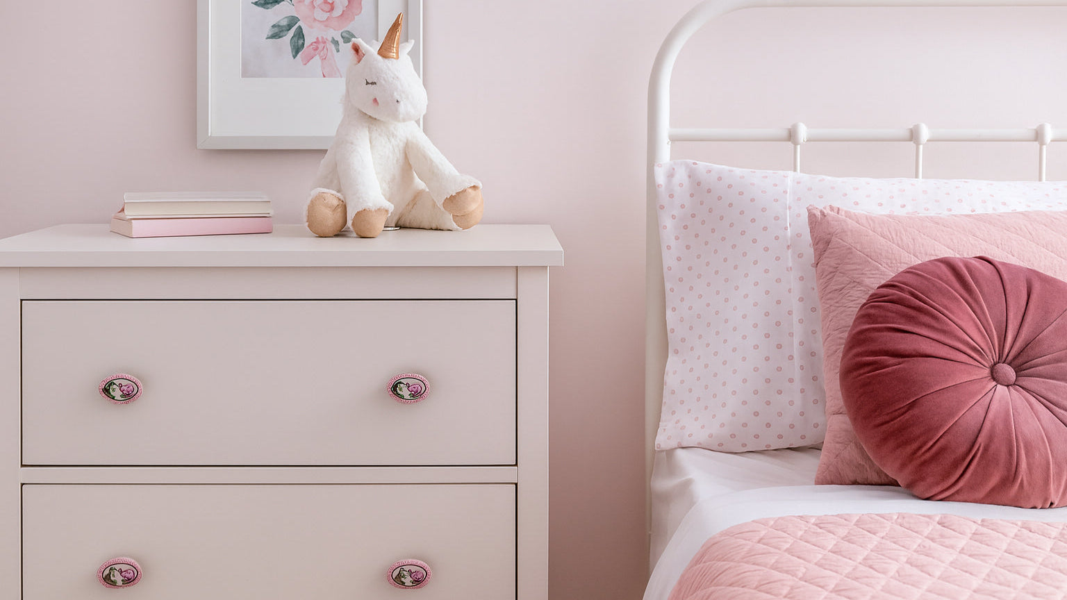 Teen girl’s bedroom with soft pink decor and Belnua porcelain knobs featuring rose motif on drawers