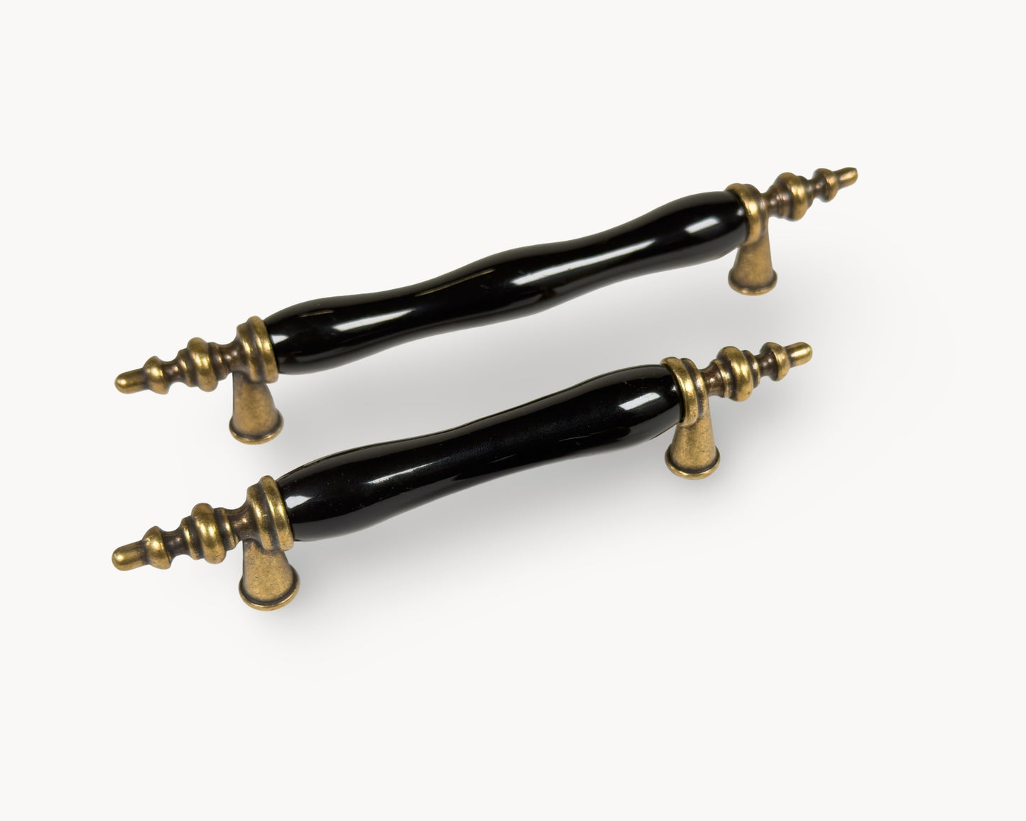 Belnua - Top left view of Velnoa antique brass cabinet handle pair with black porcelain/ceramic insert 