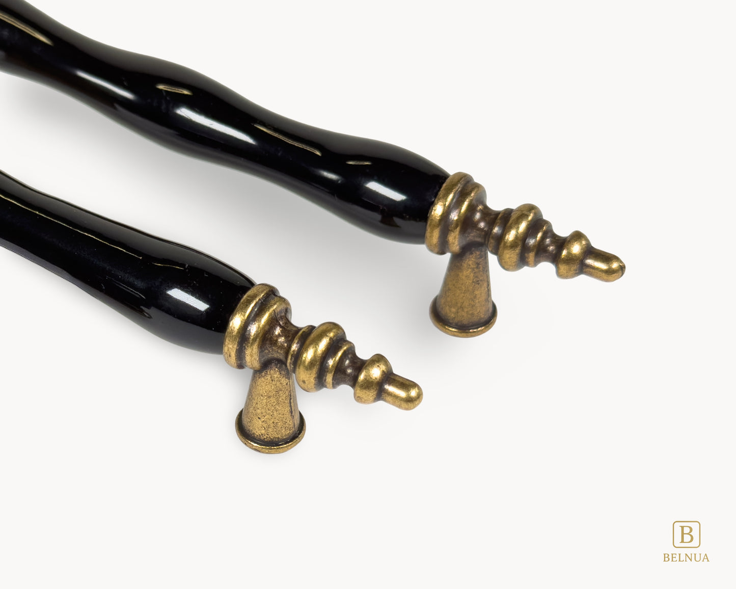 Belnua - Closeup view of Velnoa antique brass cabinet handle pair with black porcelain/ceramic insert 