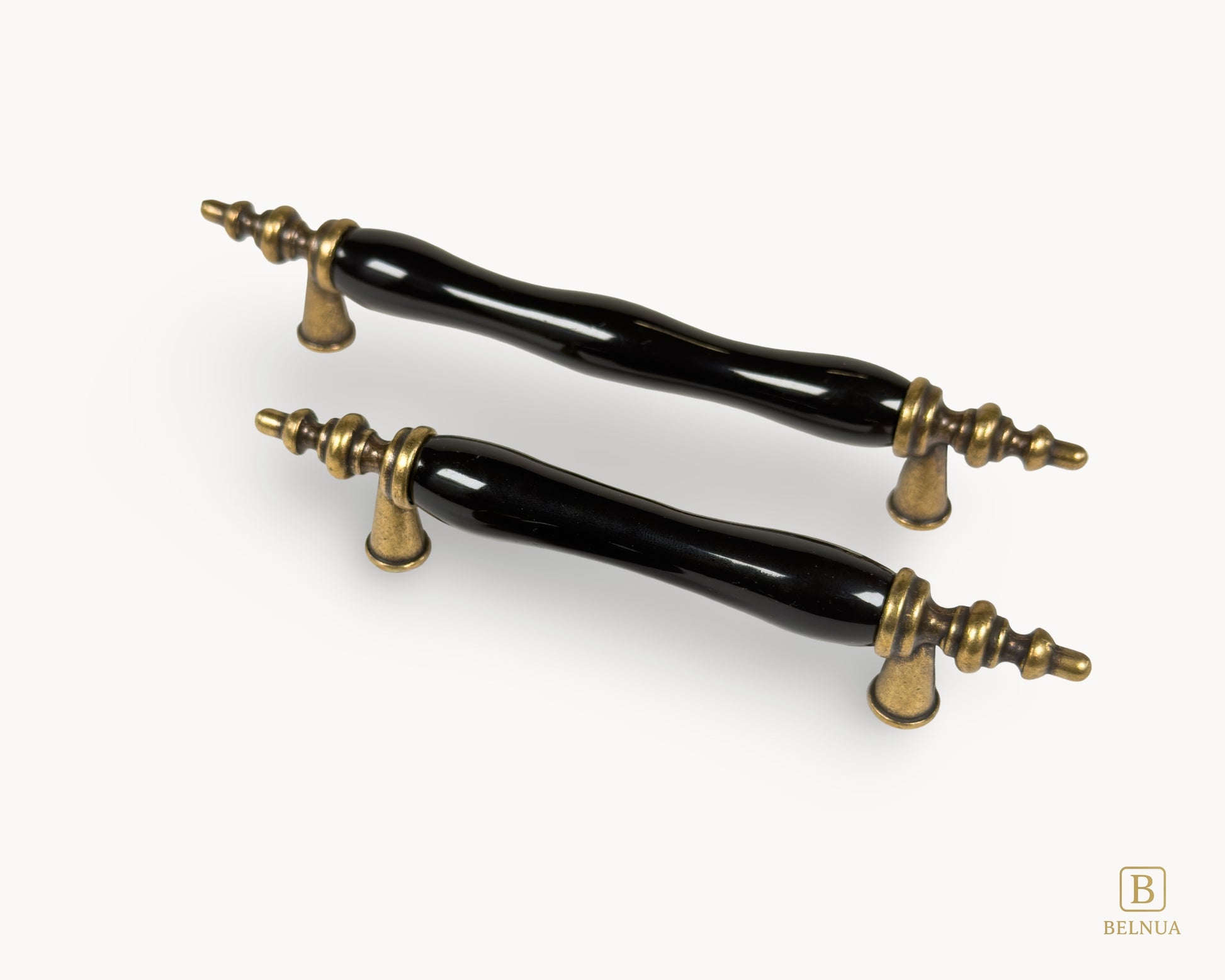 Belnua - Top right view of Velnoa antique brass cabinet handle pair with black porcelain/ceramic insert 
