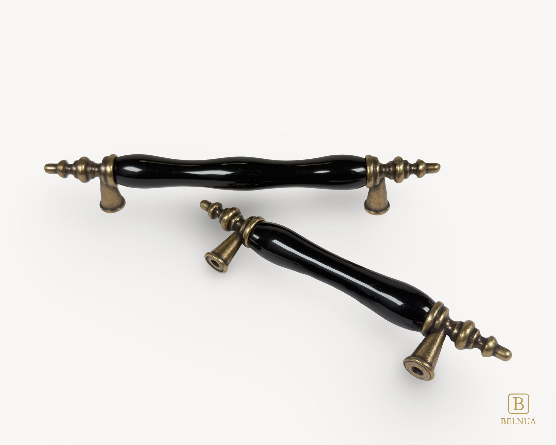 Belnua - Top view of Velnoa antique brass cabinet handle pair with black porcelain/ceramic insert featuring front and back of handle