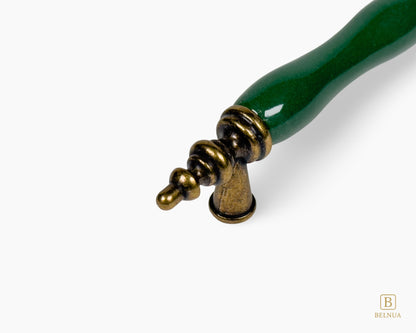 Belnua - Close up view antique brass finish of VELNOA dark green porcelain handle
