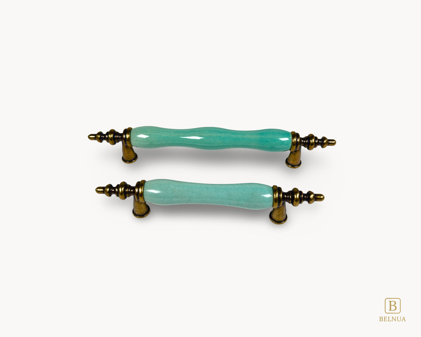 Belnua - Front top view of VELNOA cabinet handle in antique brass finish with turquoise porcelain insert featuring brass and ceramic details