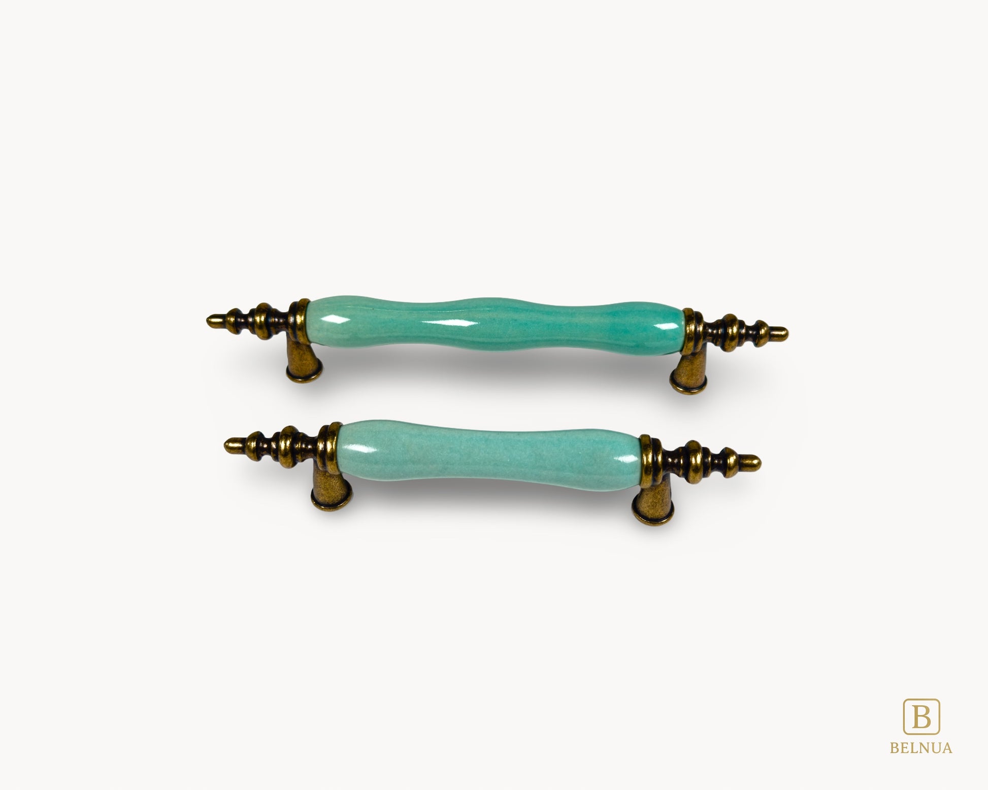 Belnua - Front top view of VELNOA cabinet handle in antique brass finish with turquoise porcelain insert featuring brass and ceramic details
