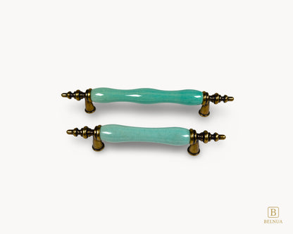 Belnua - Front top view of VELNOA cabinet handle in antique brass finish with turquoise porcelain insert featuring brass and ceramic details