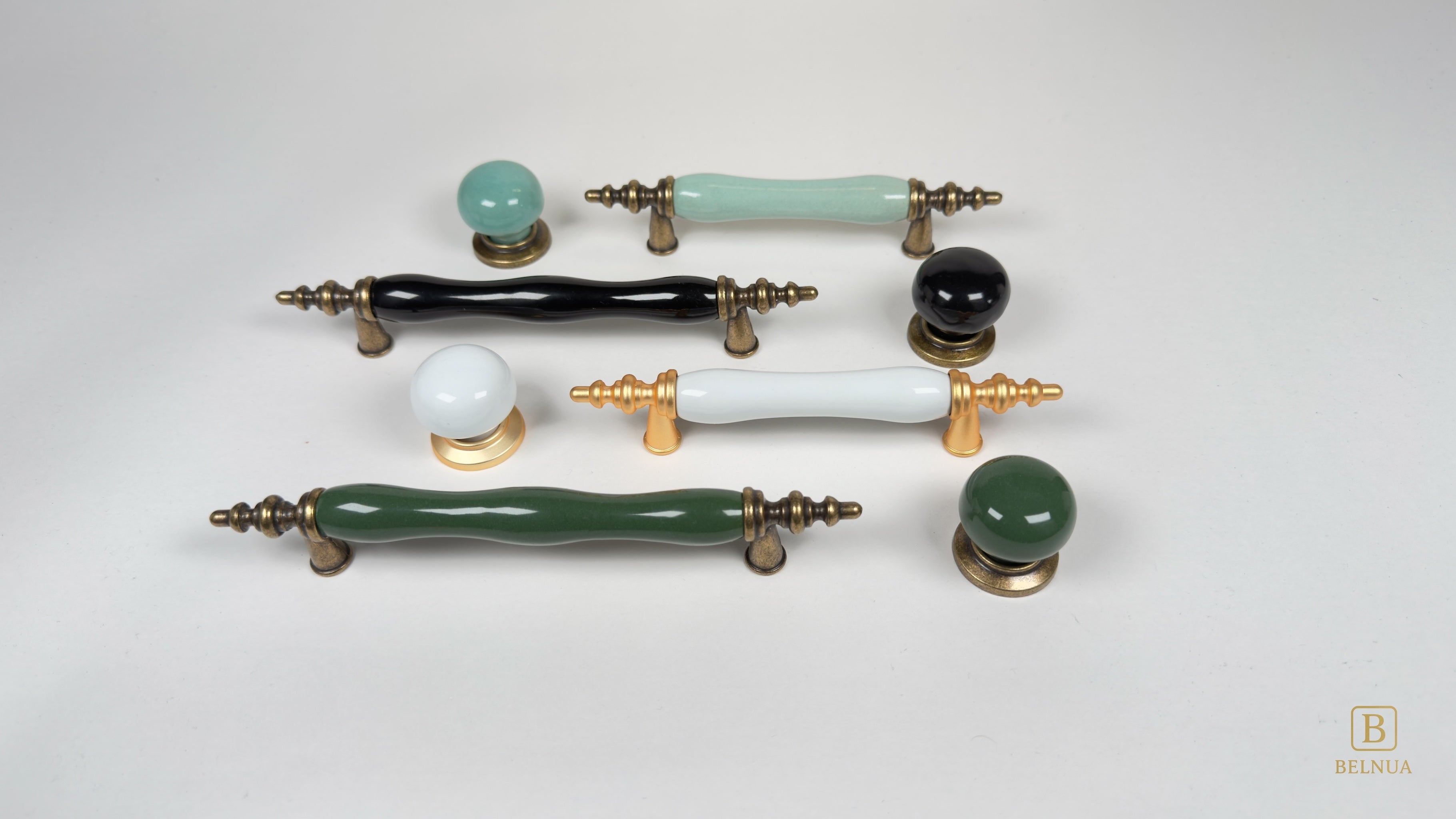 Belnua Velnoa and Zerra matching collection featuring porcelain cabinet handles and knobs in white, black, turquoise and dark green with antique brass and matte gold metal bases.