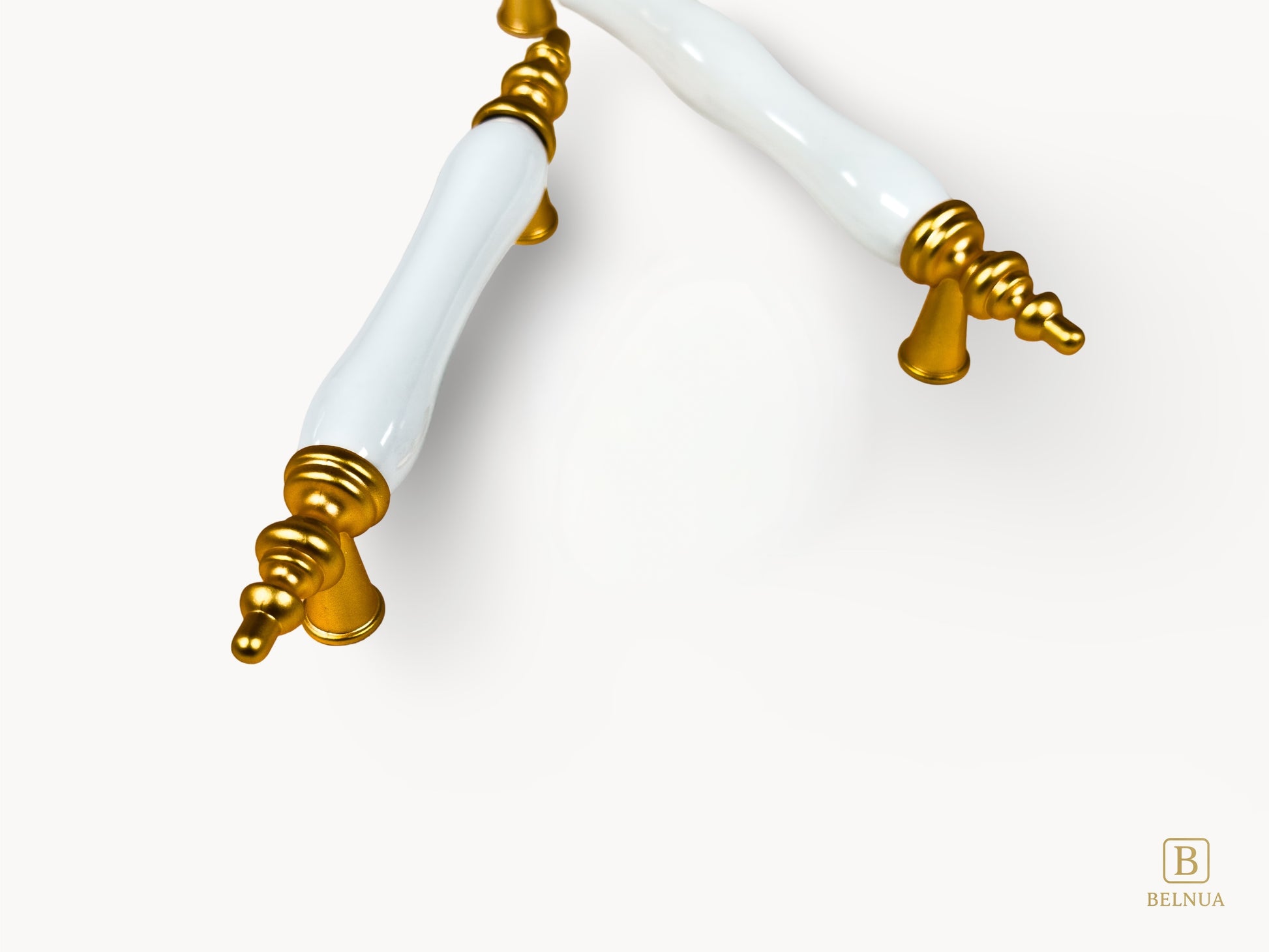 Belnua - Closeup view of Velnoa matte gold cabinet handle pair with plain white porcelain/ceramic insert