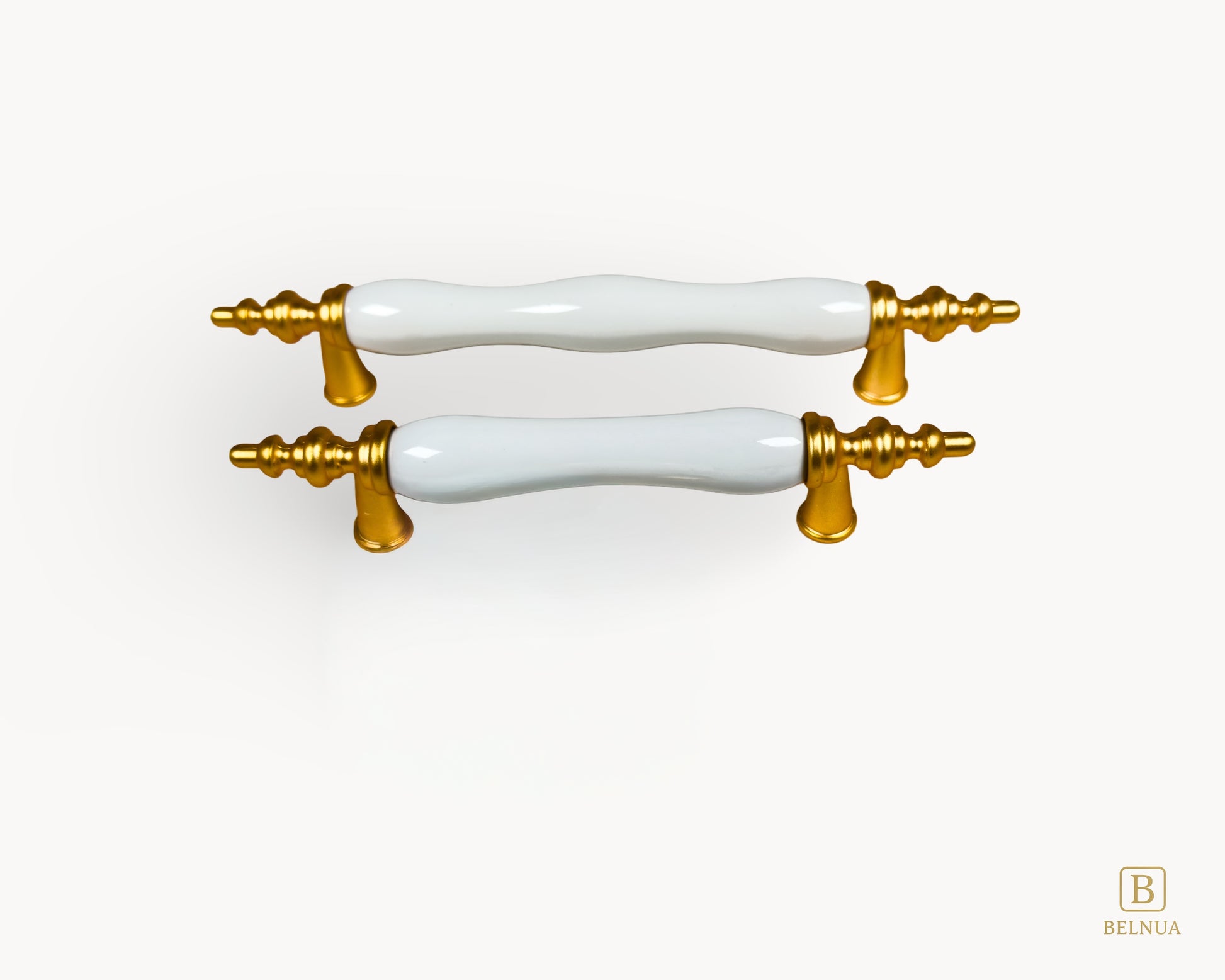 Belnua - Front top view of Velnoa matte gold cabinet handle pair with plain white porcelain/ceramic insert