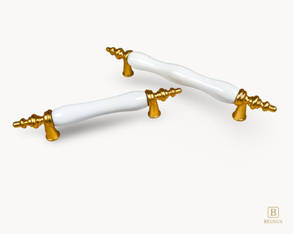 Belnua - Top angled of Velnoa matte gold cabinet handle pair with plain white porcelain/ceramic insert with white background