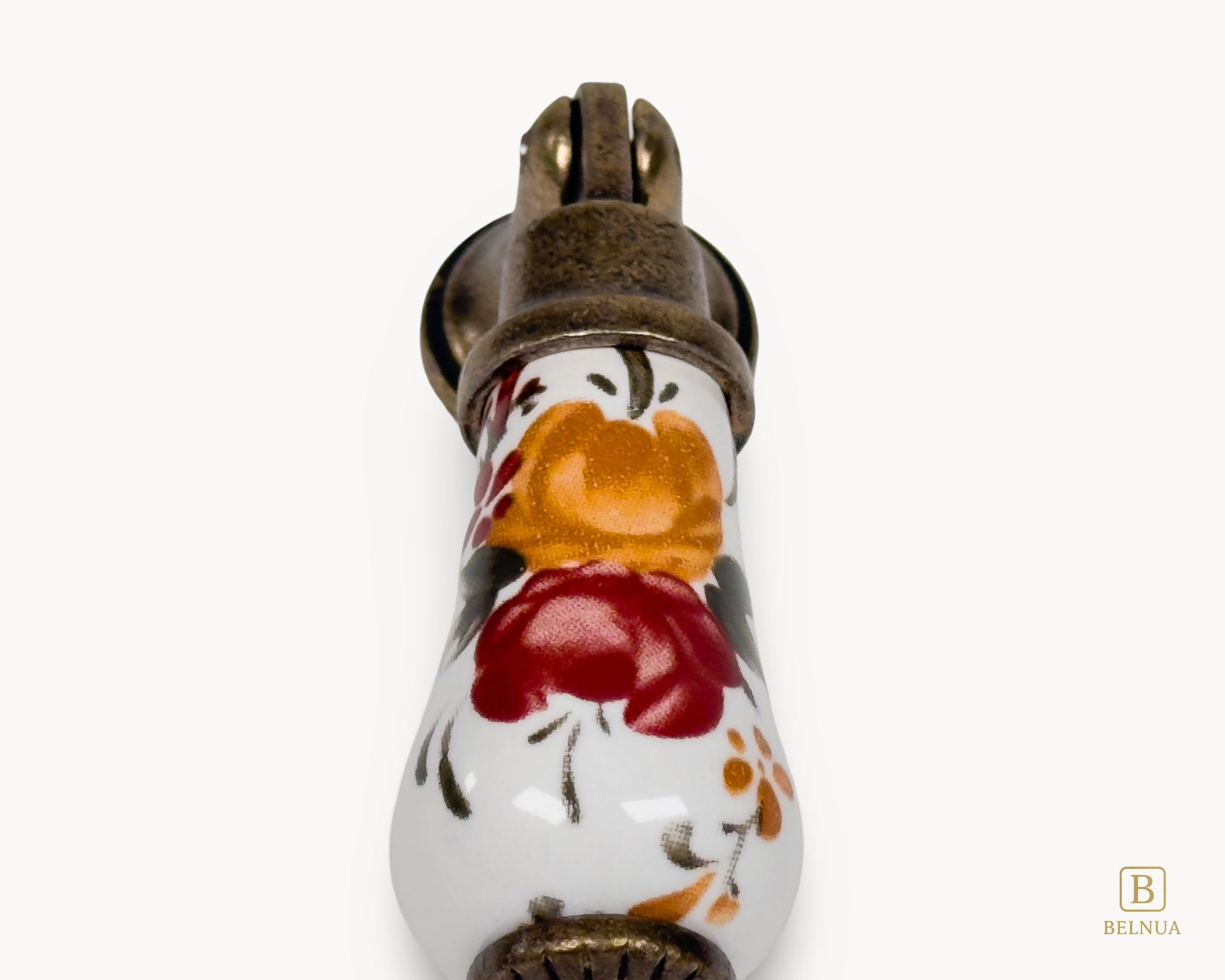 Close-up of hand-painted floral porcelain detail on Verossa handle with antique brass hardware