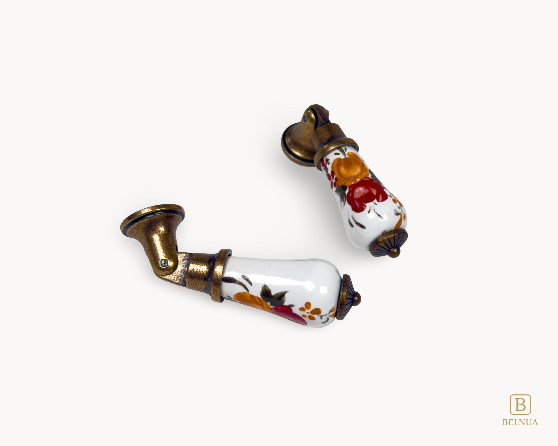 Styled angled view of Verossa porcelain handle featuring floral ceramic body and antique brass hardware