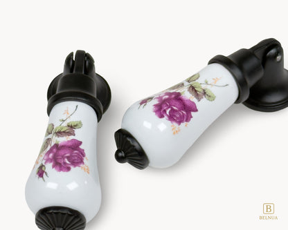 Multiple Verossa porcelain handles displayed together showing rose floral pattern and black finish