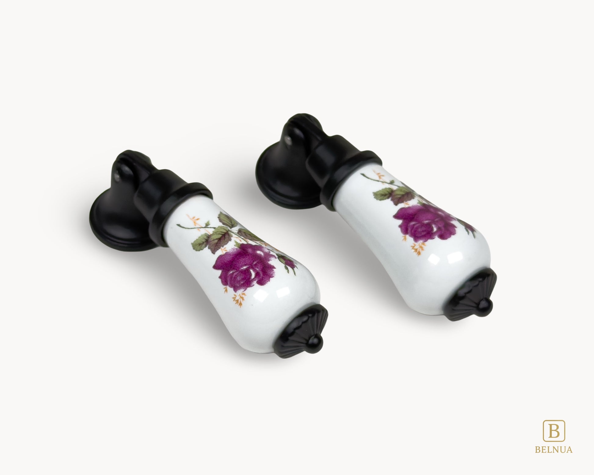 Single Verossa porcelain handle isolated on white background with floral rose detail and black base