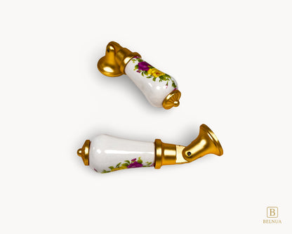 Top view of floral porcelain handle with gold detailing, showing pattern placement and finish.