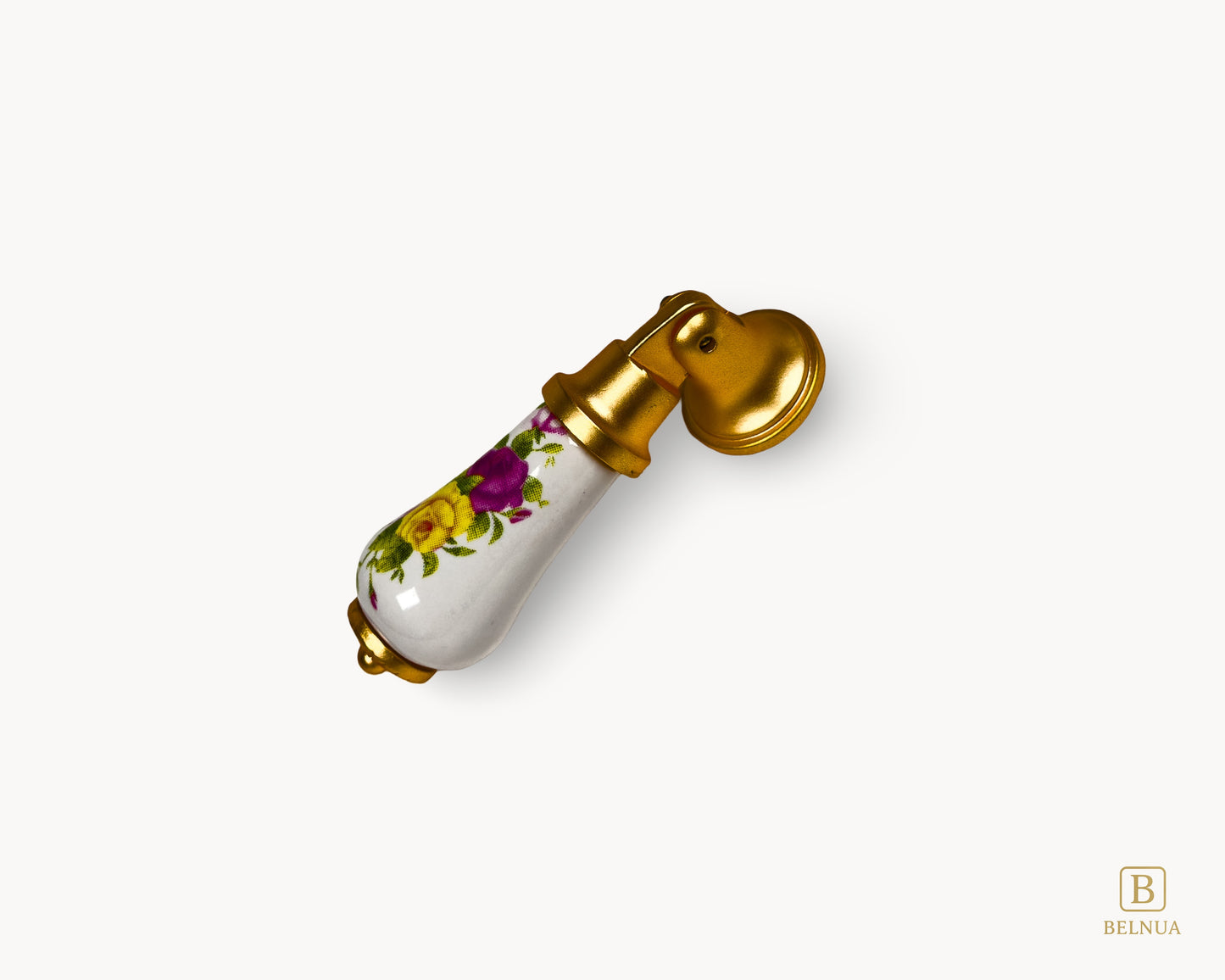 Diagonal view of floral porcelain handle emphasizing gold base and decorative ceramic body.