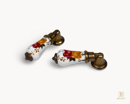 Perspective view of Verossa porcelain handle showing curved ceramic form and antique brass base