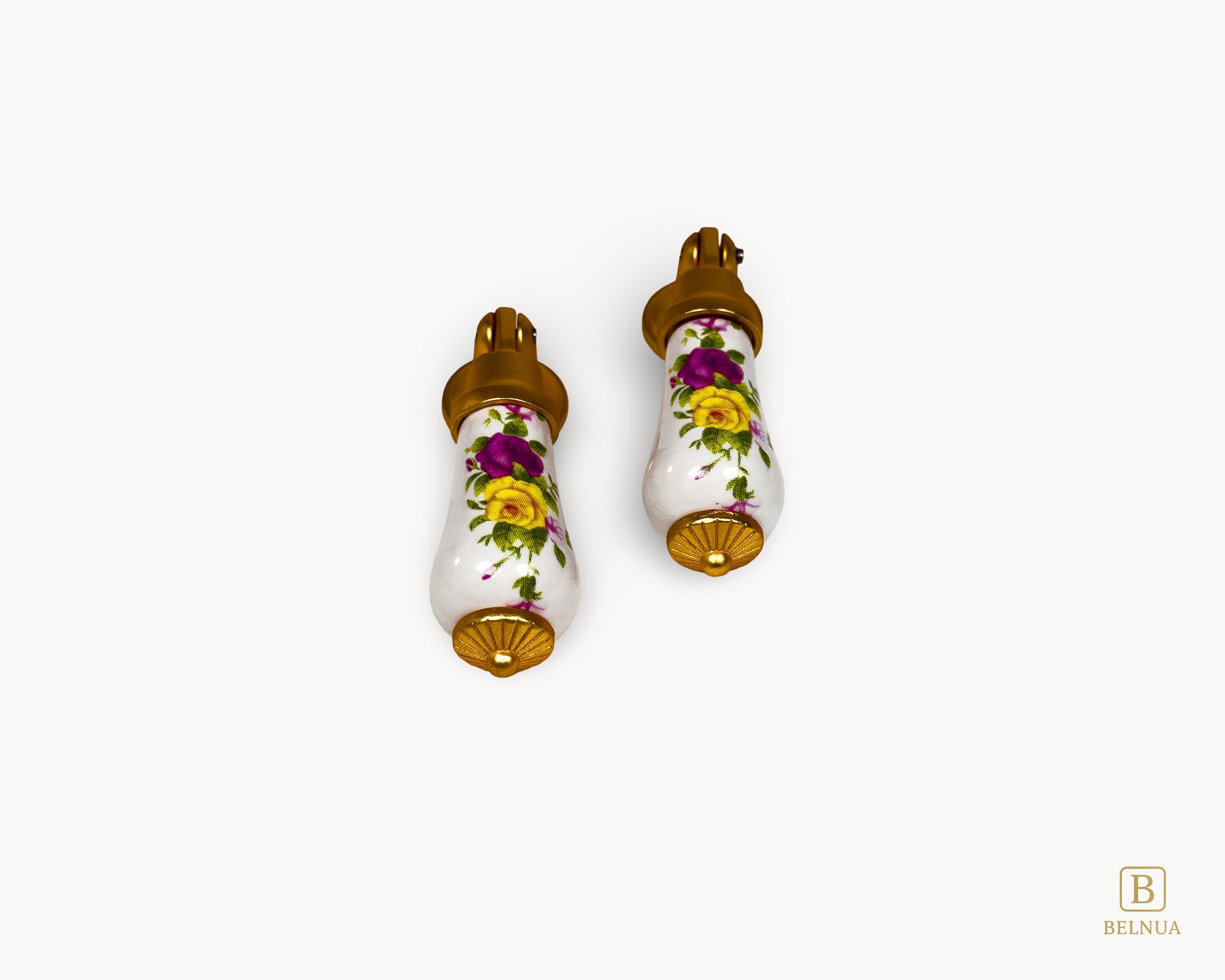 Front-facing pair of floral porcelain handles with gold bases suitable for cabinets or drawers.