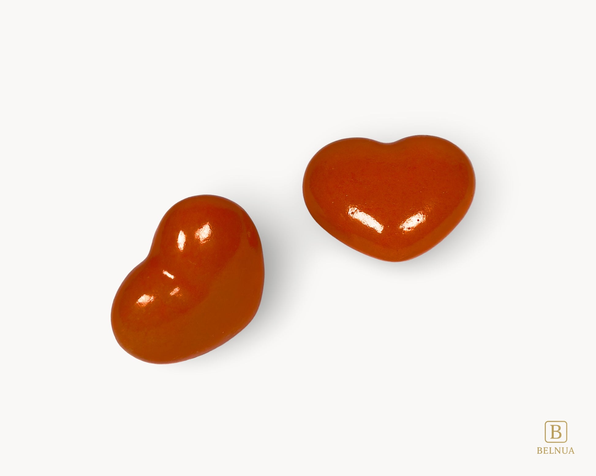 Diagonal view of Belnua Veyla orange heart-shaped porcelain cabinet knobs