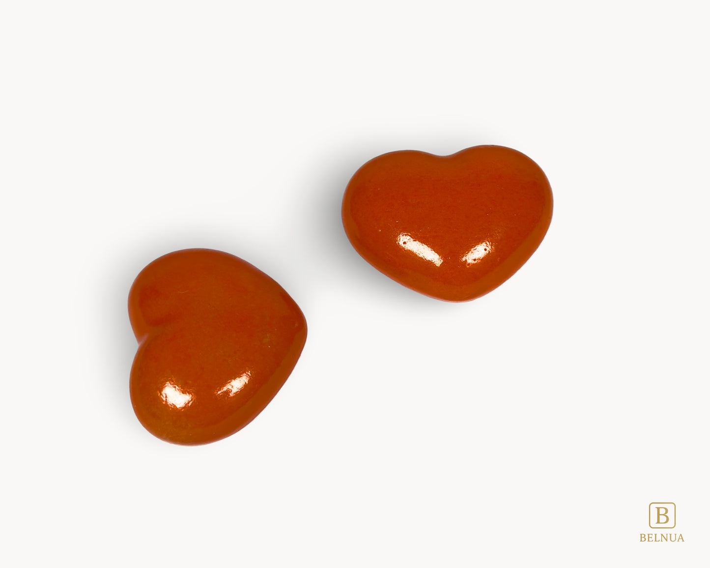 Side profile of Belnua Veyla orange heart-shaped porcelain cabinet knob