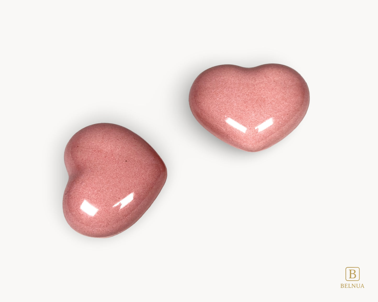 Angled view of a pink porcelain heart knob from the Belnua Veyla collection.