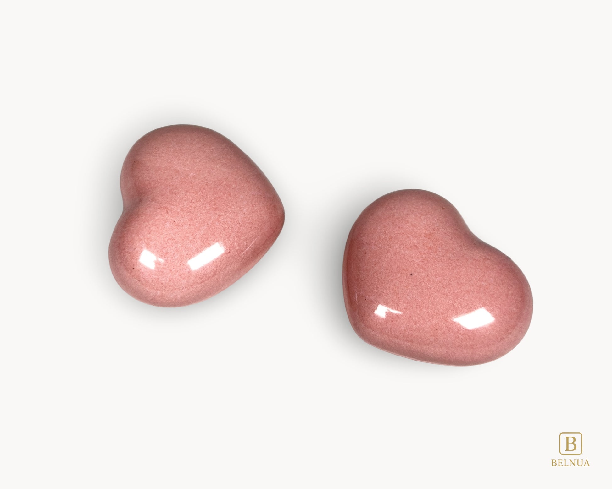 Close-up detail of the Belnua Veyla pink porcelain heart knob showing smooth glaze and craftsmanship.