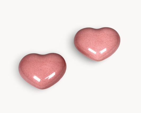 Hero image of Belnua Veyla pink porcelain heart knob pair highlighting glossy finish and colour.