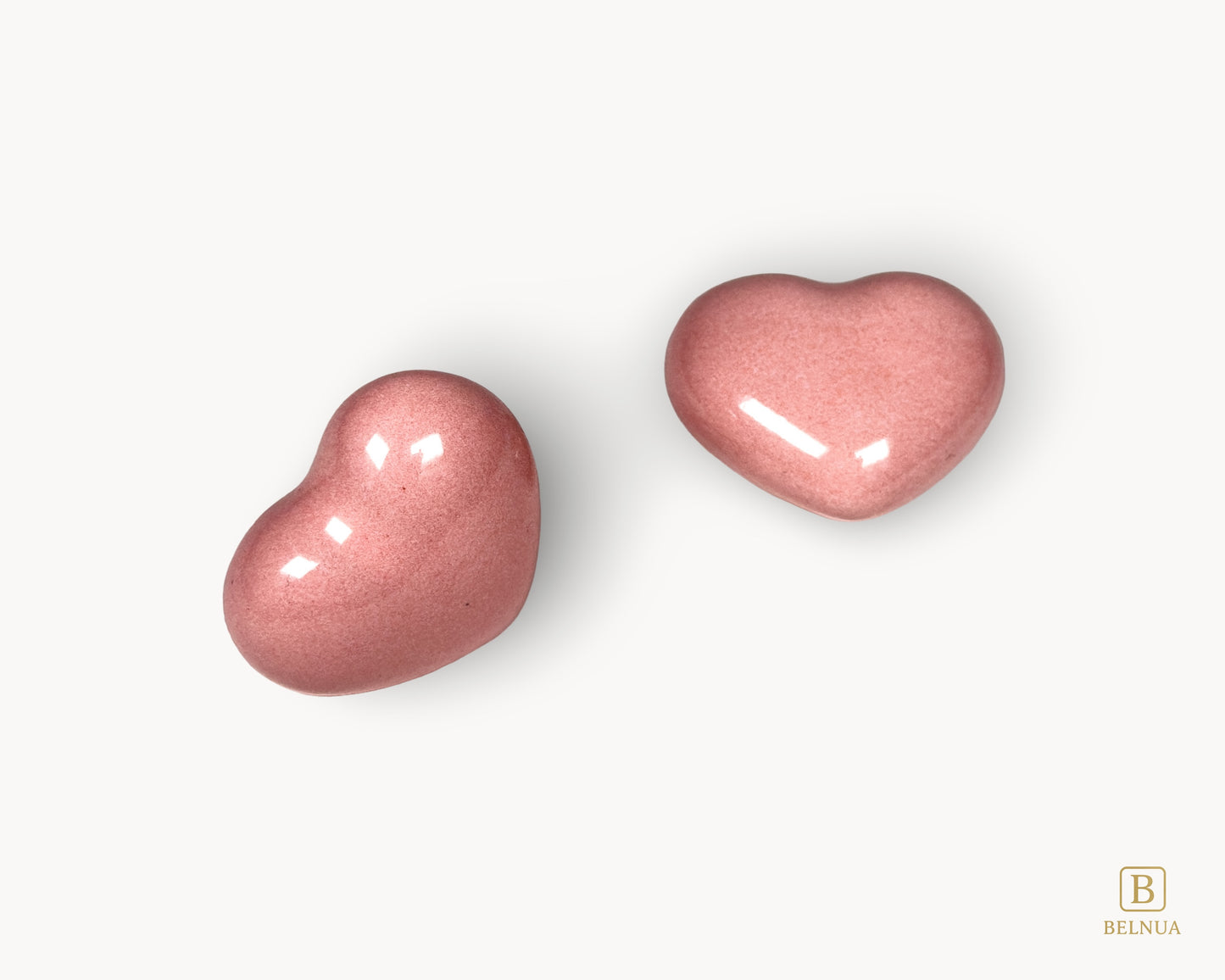 Minimal composition featuring Belnua Veyla pink porcelain heart knobs on a neutral background.
