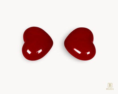 Two Belnua Veyla red porcelain heart knobs in balanced composition