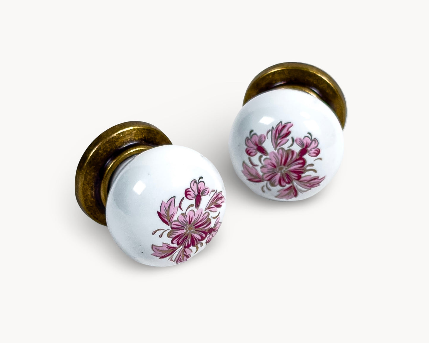 Belnua - Detailing petal motif with front and side view of ZERRA white porcelain/ceramic knob pair with antique brass base
