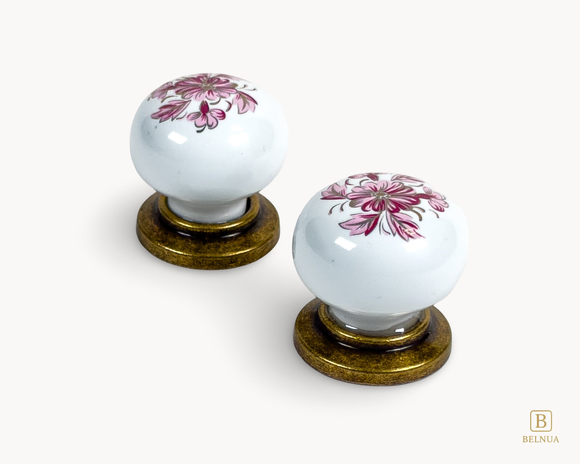 Belnua - Top close up view of ZERRA white porcelain/ceramic knob pair with antique brass base featuring details of petal motif on white cabinet knob