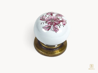 Belnua - Top closeup view of ZERRA cabinet knob with vintage petal motif on white porcelain and antique brass base