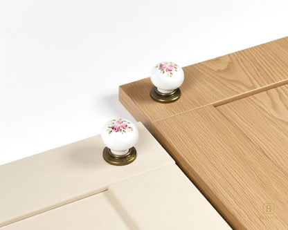 Belnua - Antique brass base ZERRA porcelain/ceramic white knob with Wildflower Garden design on cashmere and warm wood cabinet door showcase
