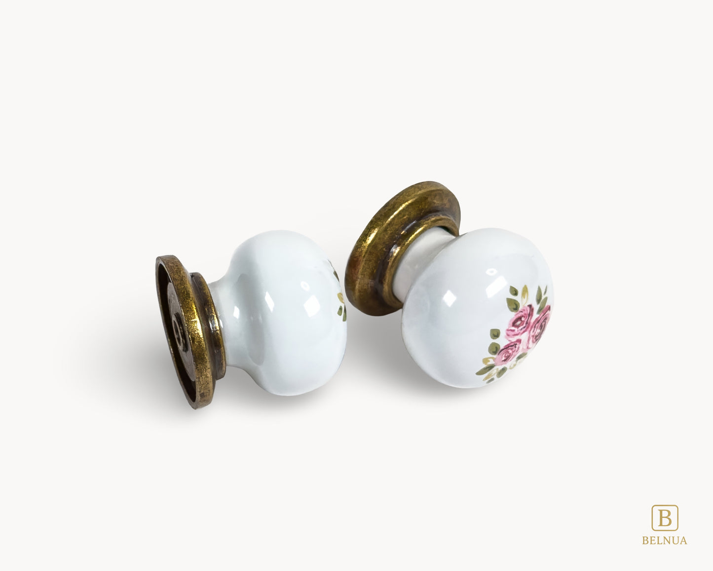 Belnua - Flat lay view of ZERRA porcelain/ceramic white knob pair in vintage style antique brass finish with Wildflower Garden design