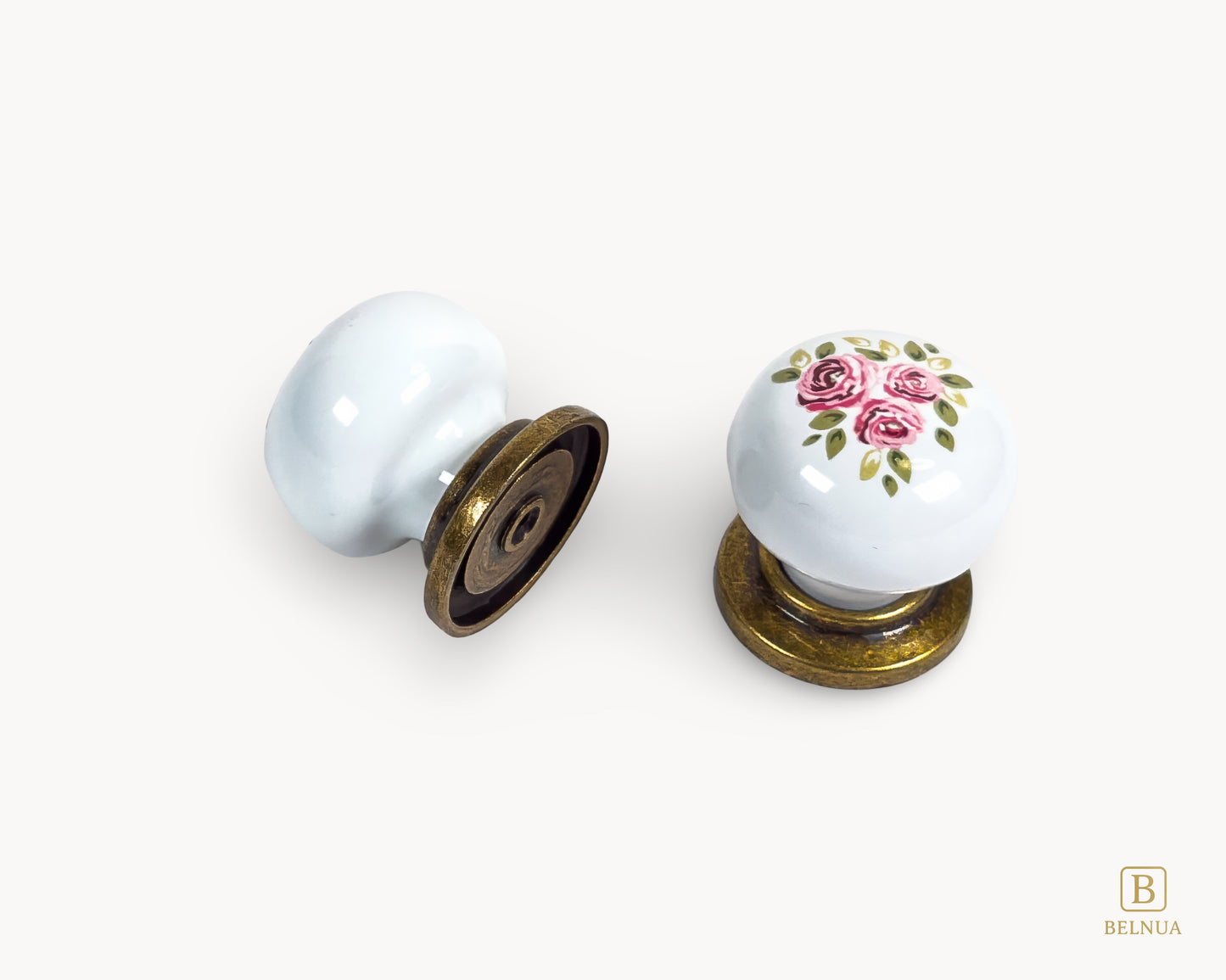 Belnua - Top and back view of ZERRA porcelain/ceramic white knob pair in vintage style antique brass finish with Wildflower Garden design