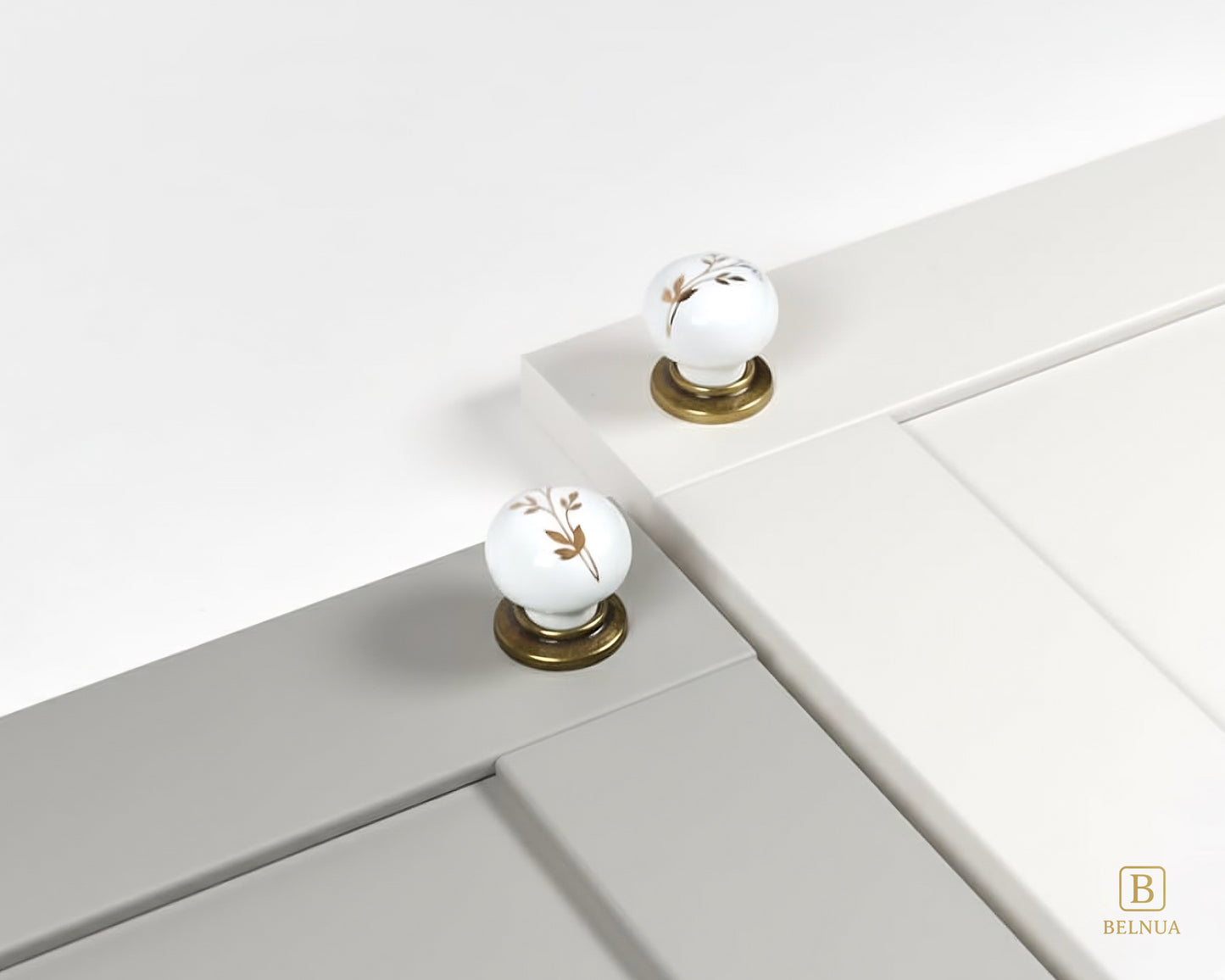 Zerra Ceramic/porcelain cabinet knobs with floral design on a porcelain white and light gray cabinet | Belnua