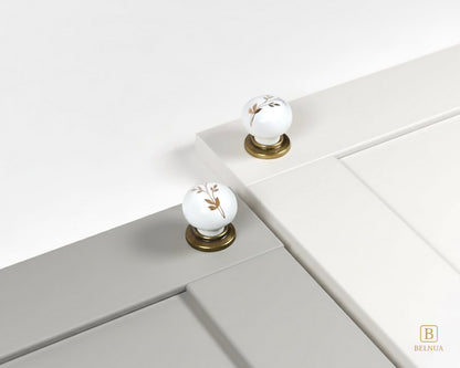 Zerra Ceramic/porcelain cabinet knobs with floral design on a porcelain white and light gray cabinet | Belnua