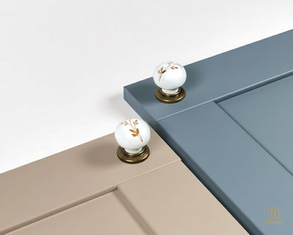 Close-up of light taupe and dusty blue cabinet with Zerra decorative white knobs | Belnua