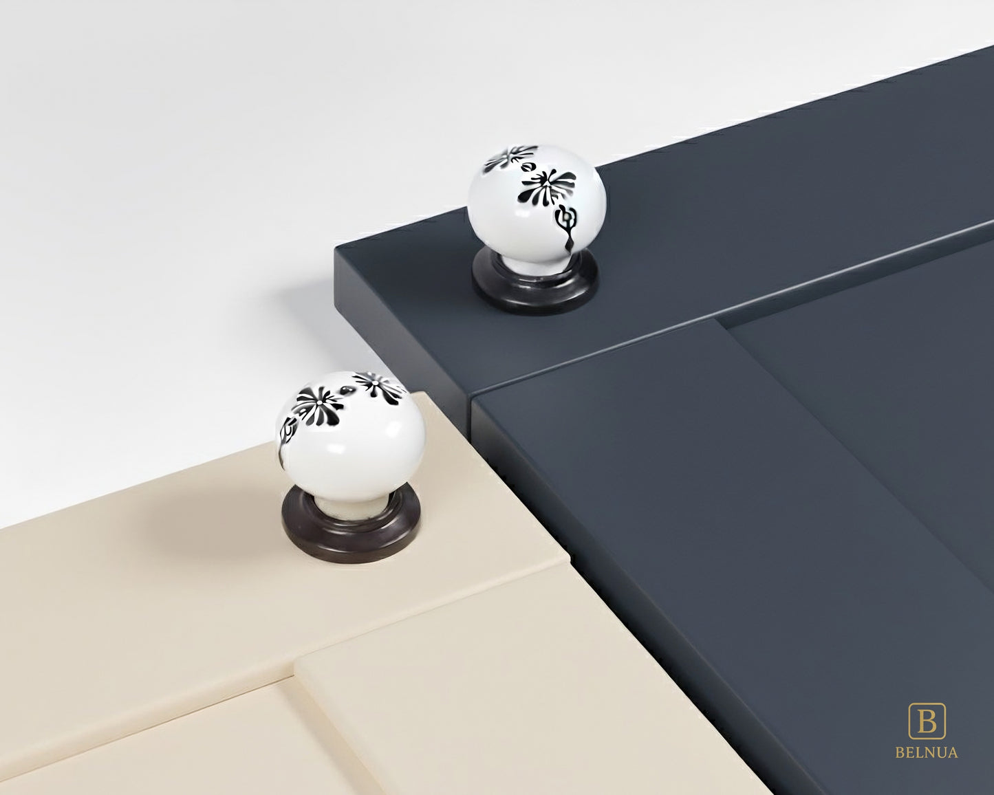 Belnua - ZERRA black and white porcelain knob with midnight blossom motif on cream and navy blue cabinet door