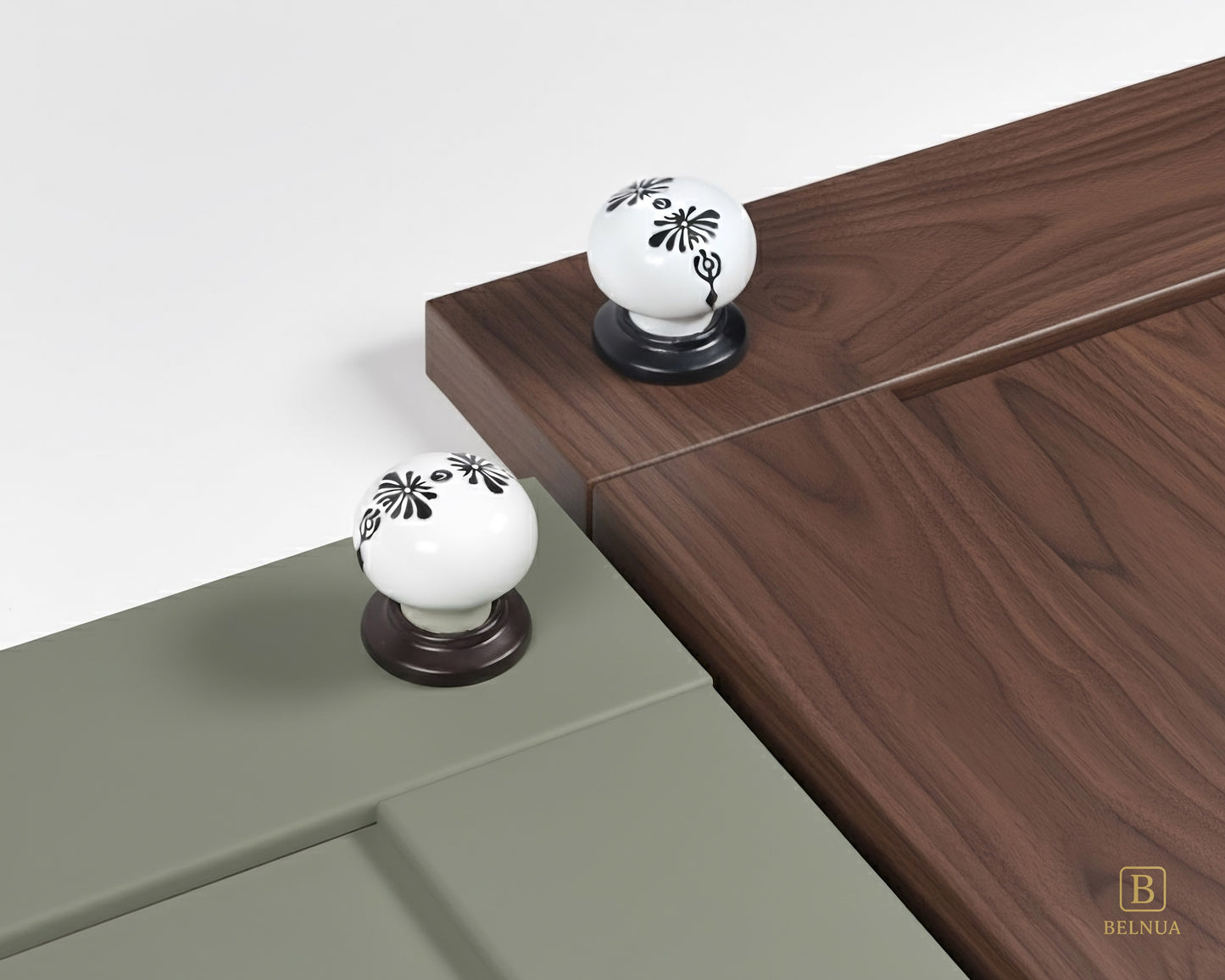 Belnua - ZERRA black and white porcelain knob with midnight blossom motif on sage green and walnut cabinet door