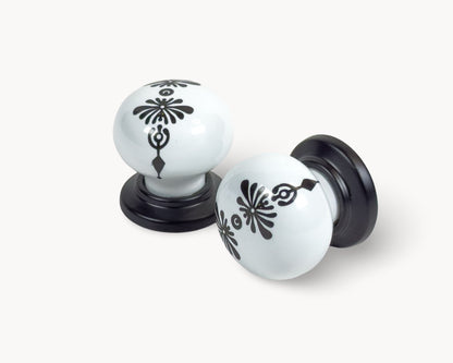 Belnua - ZERRA knob with midnight blossom motif on white ceramic/porcelain and matte black base